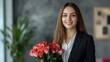 © Tobi - A poised businesswoman in a contemporary office environment holding roses with a friendly expression