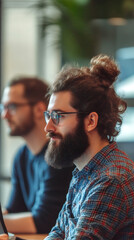 Leinwandbilder - Young professional concentrating while working on a project in a modern office, showcasing dedication and expertise in web development