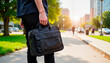 © Kseniya - Casually dressed young adult walking with messenger bag, urban vibe