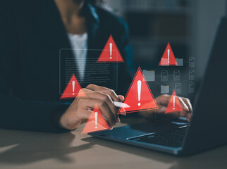 businessman using laptop with spam virus with warning for internet security alert and data breach or