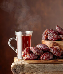 Poster - Tea and dates on a old wooden table.