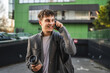 © Miljan Živković - happy adult young man and talk on mobile phone on the street