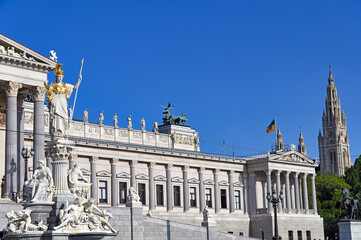 Wall Mural - Pallas Athena statue in front of Austrian Parliament and Rathaus tower in Vienna,Austria