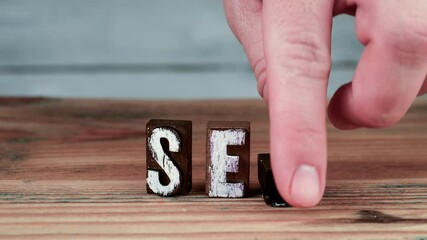 Wall Mural - seo. spelling word using wooden alphabet blocks