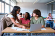 © CarlosBarquero - Young male teacher helping female student in class. The tutor helping his students by explaining the lesson and solving doubts. High quality photo
