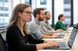 © Наталья Лазарева - Focused professionals working on laptops during a corporate training session, ideal for concepts of education, teamwork, productivity, or workplace development in a modern office setting