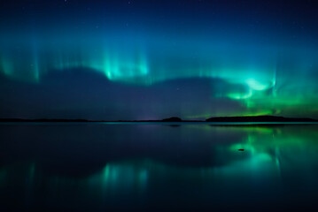 Wall Mural - northern lights dancing over lake. farnebofjarden national park.