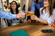 © Mediteraneo - Group of friends toasting in a restaurant with alcohol.