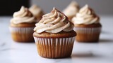 Delicious cupcakes with creamy frosting, sprinkled with cinnamon. Perfect for blogs, websites, or menus showcasing sweet treats and desserts.