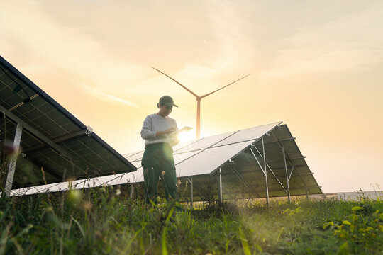 Fototapete -  - Female farmer with digital tablet on a modern farm using solar panels.