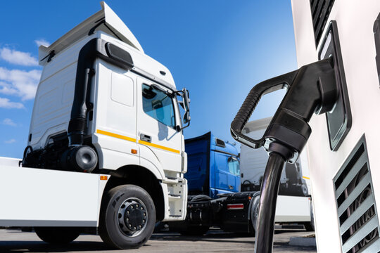 Fototapete -  - Electric vehicles charging station on a background of a trucks
