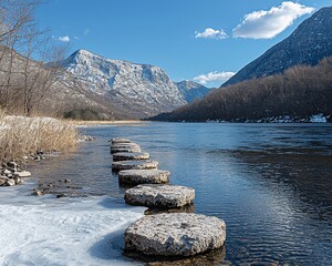 Wall Mural - Stepping stones in a river, leading to snowy mountains under a blue sky.