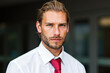 © Minerva Studio - Portrait of confident businessman posing in white shirt and red tie