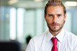© Minerva Studio - Portrait of confident businessman posing in modern office