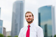 © Minerva Studio - Young businessman looking up at skyscrapers in Milan, Italy