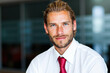 © Minerva Studio - Portrait of a confident businessman smiling in modern office