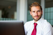 © Minerva Studio - Young businessman working on laptop in modern office