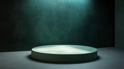 Poster - Circular pedestal on dark floor against teal textured wall, illuminated by spotlight.