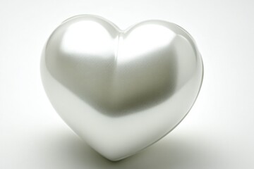 Sticker - A shiny silver heart shaped object sits on a white surface