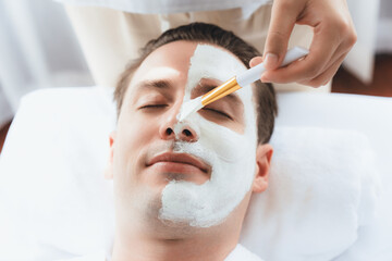 serene ambiance of spa salon, man customer indulges in rejuvenating with luxurious face cream massag