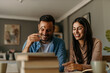 © La Famiglia - Modern living. Couple balancing their budget in a stylish, airy interior