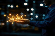 © Mselected - Person creates magical light sparks in their hand during a nighttime setting