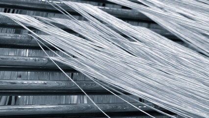 Aufkleber - Coils of synthetic textile thread thread at industrial weaving manufacturing machine