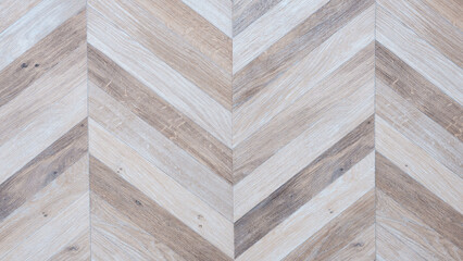Poster - A wooden floor with a chevron pattern. The chevron pattern is made up of different wood types and is very intricate