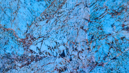 Poster - A blue and white rock with a lot of cracks and holes. The blue is very bright and the white is very light