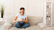 © Prostock-studio - Student Girl With Smartphone Listening To Podcast In Earphones Learning Distantly Sitting On Sofa At Home. Weekend Leisure Concept. Panorama