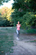 © Solid photos - Young woman jogging in the nature in summer