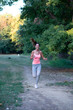 © Solid photos - Young woman jogging in the nature in summer