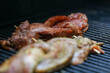 © Mat Hayward - Pork loin cooking on a grill. The meat is twisted like a pretzel for a unique barbecue meal.
