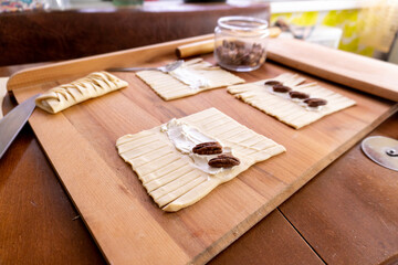 Wall Mural - The process of making puff pastry with cream cheese and pecans. Baking concept. Homemade food. Baking cakes in the oven.