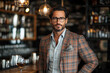 © kristina - Man in plaid jacket and glasses at bar.
