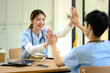 © Prathankarnpap - Happy medical students give each other a high five celebrating in their studies and achievement