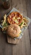 © chaiwat - A delicious pizza burger and crispy fries displayed on a rustic wooden table, indulgent, cafe