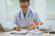 © R Photography - Male doctor treating female uterine diseases at hospital table, discussing uterine disease models,diagnosing uterine tumors, endometriosis,bacterial vaginitis,cervical cancer,HPV-related infections
