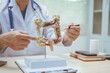 © R Photography - Male doctor treating intestinal diseases at a hospital table, discussing intestinal disease models, diagnosing gastritis ileitis,appendicitis, colon cancer,providing treatment plans and patient care
