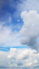 Wall Mural - Beautiful fluffy clouds drifting across a bright blue sky during a sunny afternoon in a peaceful outdoor setting. Calm and romantic background with clouds on the weather theme.
