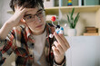 © Westend61 - Exhausted student examining molecular structure model at home