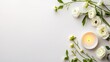 © Tam5 - White flowers and candle on white background creating a serene and peaceful flat lay design