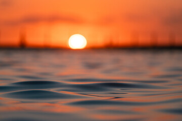 Wall Mural - Close-up view of ocean water surface during sunrise.