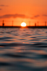 Wall Mural - Close-up view of ocean water surface during sunrise.