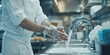 © DOUGLAS - chef in clean kitchen washes hands under running water, ensuring hygiene