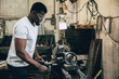 © Quality Stock Arts - african black male worker working in heavy industry metal factory using steel lathe machine
