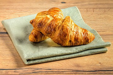 Golden croissants on a napkin.