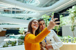 © Jacob Lund - Female colleagues take a selfie on their first day at work