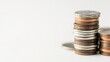 © hathairat - A Close-Up View of Stacked Coins on a Neutral Background Highlighting the Intricacies of Currency and the Concept of Saving and Investing Money Wisely