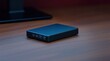 © Rafal Rut - Compact external hard drive on a wooden desk, near a monitor.  Ideal for data storage and backup.